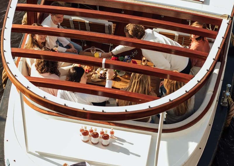 Amsterdam: Luxury Saloon Boat Cruise with Cocktails & Waffle - NEMO and the Maritime Museum Area: Modern Meets Classic Canals