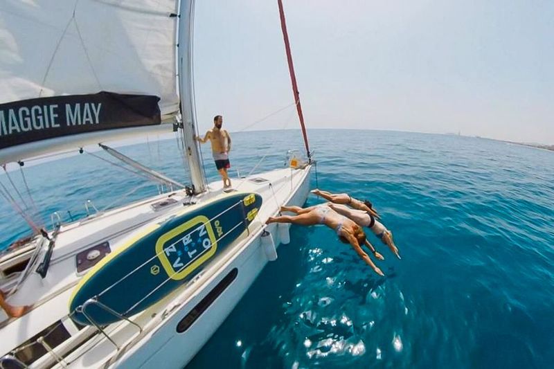 Barcelona: Coastline Boat Trip with Snacks and Cava - Music, social energy, and the international mix