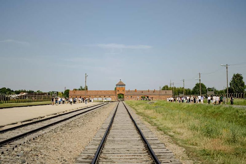 From Krakow: Auschwitz-Birkenau Live Guided Tour & Pickup - Auschwitz II–Birkenau: Rail Tracks, Gas Chambers Remains, and the Scale of Loss