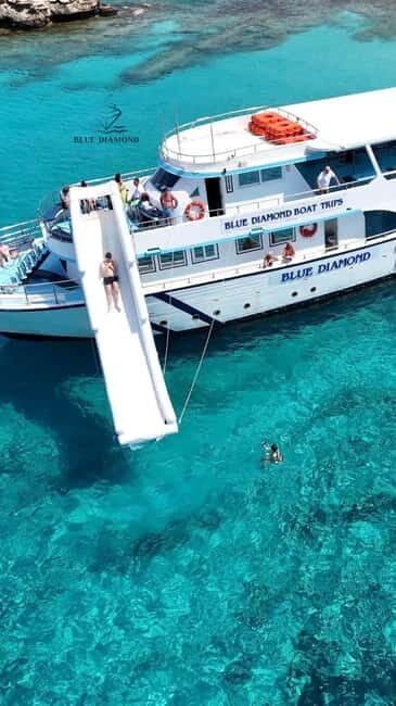 Paphos Blue Lagoon Cruise: Slide, Music & Hotel Transfer - The Scenic Boat Ride
