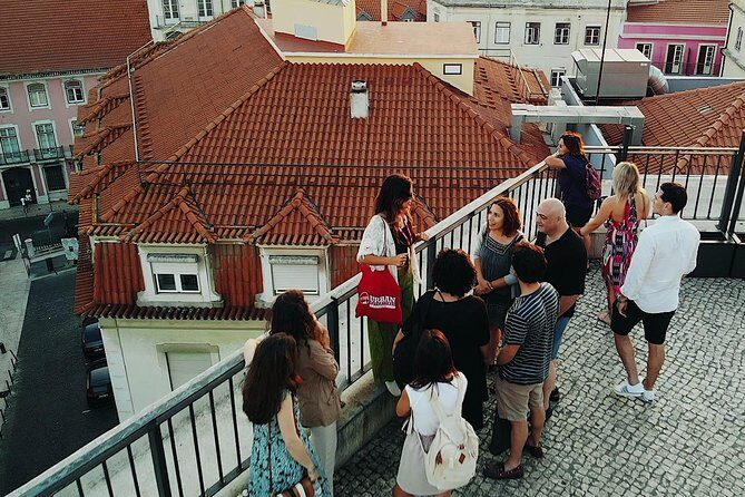 Private Tour: Lisbon Sunset Walking Tour with Fado Show and Dinner - Exploring Alfamas Nighttime Charm
